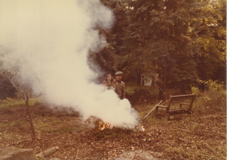 Madeline and Arakawa near a smoky campfire